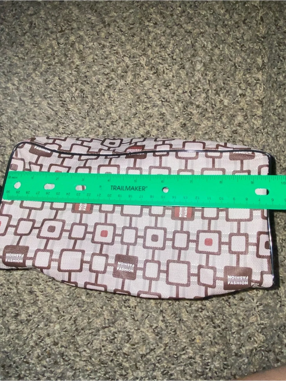 Brown and white geometric patterned travel toiletry bag